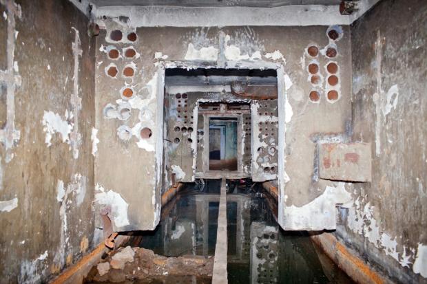 Третий этаж заброшенного советского ракетного бункера недалеко от Елгавы. Отпечатки рук над каждым проемом — помеченные места, куда забирались предыдущие исследователи. Им приходилось балансировать на бетонной балке, возвышающейся над затопившей нижние уровни комплекса водой.