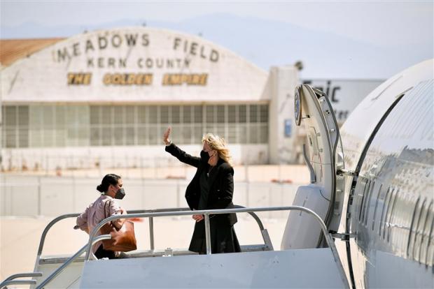 Image: First lady Jill Biden waves as she boards a plane before departing from Meadows Field Airport in Bakersfield, California